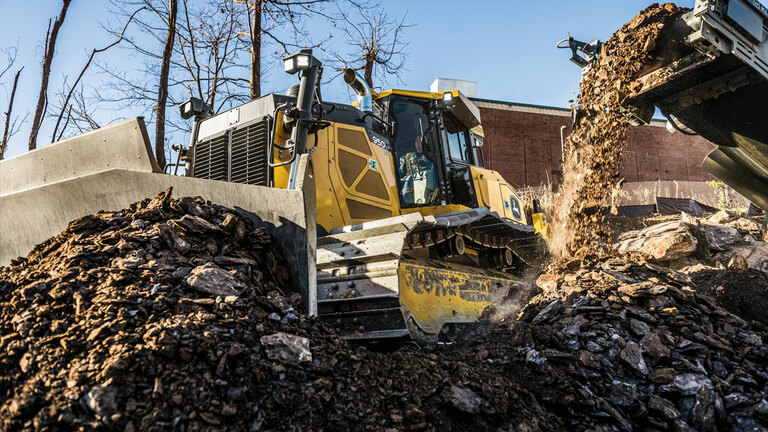 950 P-Tier dozer moving crushed rock on site.