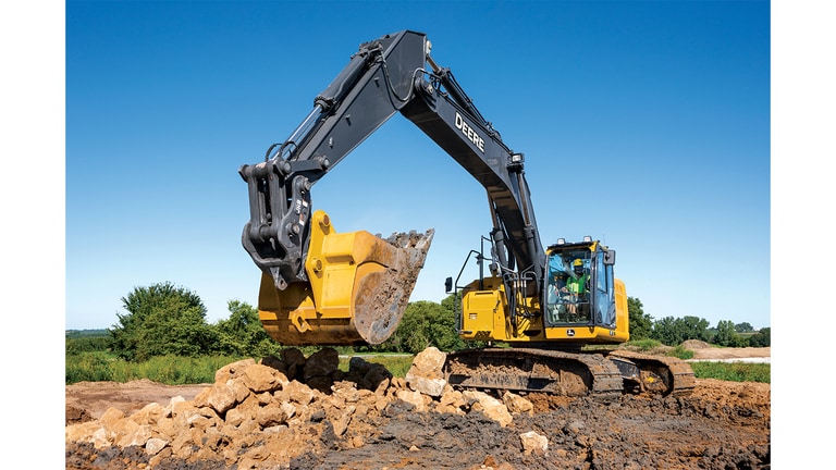A 345P-Tier Excavator moving rocks and dirt at a worksite.