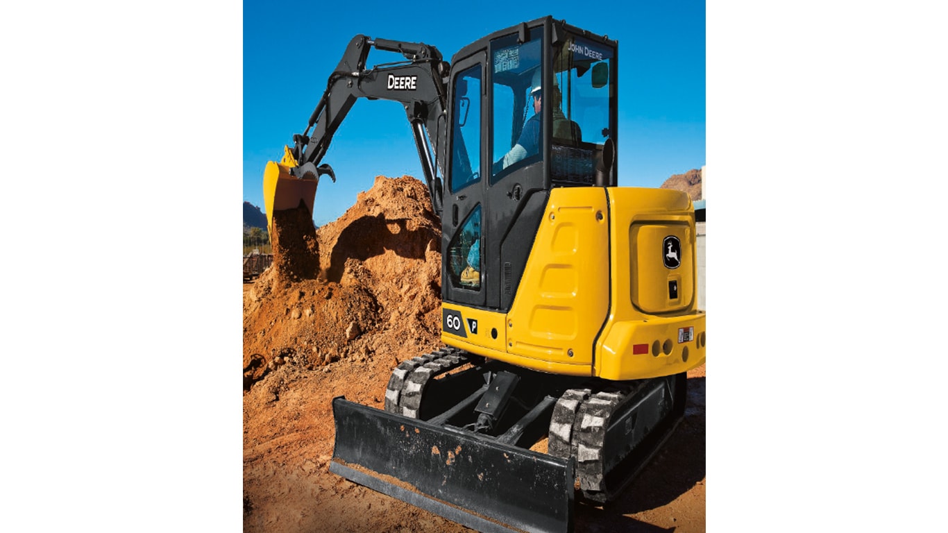 The backside of a 60P-Tier Excavator dumping dirt on a pile at a worksite.