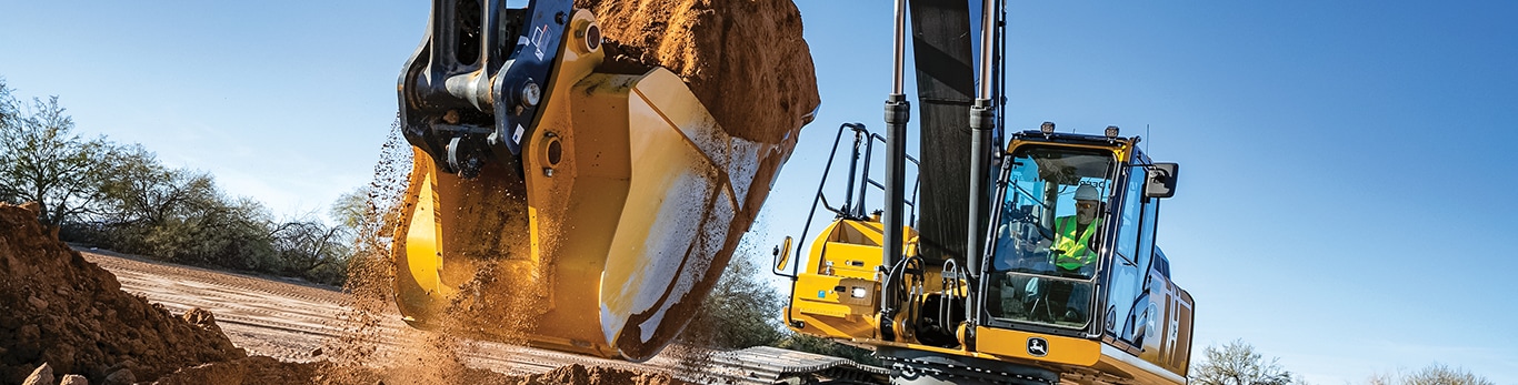 Excavator moving dirt on a work site.