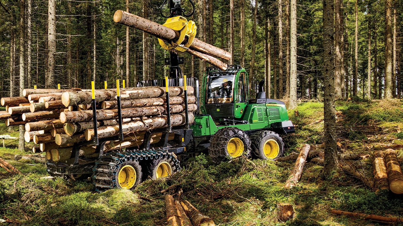 1210G forwarder hauling timber through a forest