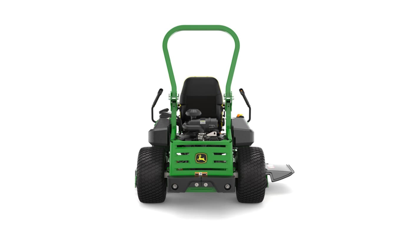 Rear view of a green and yellow riding mower with roll bar, large rear wheels, and various control