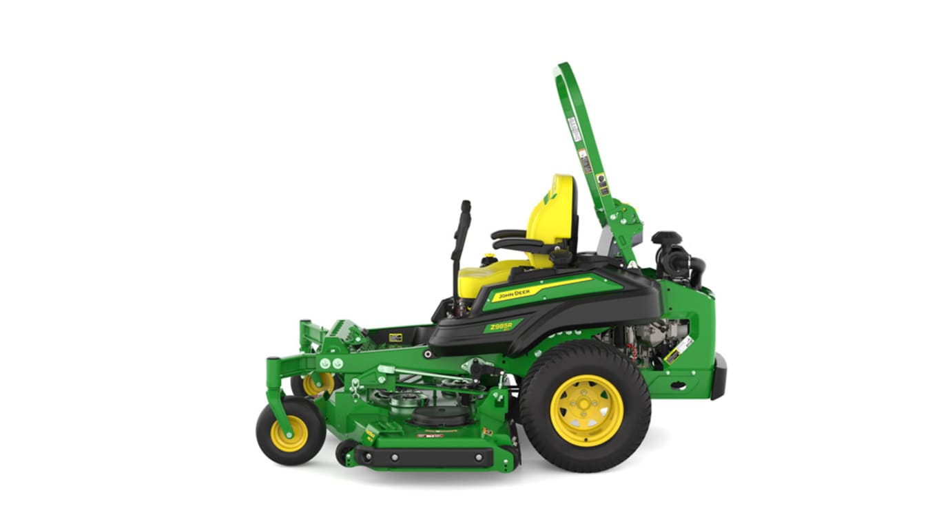 Left-side view of a green and yellow riding mower with roll bar, large rear wheels, and various controls