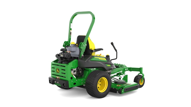 Rear-right view of a green and yellow riding mower with roll bar, large rear wheels, and various controls