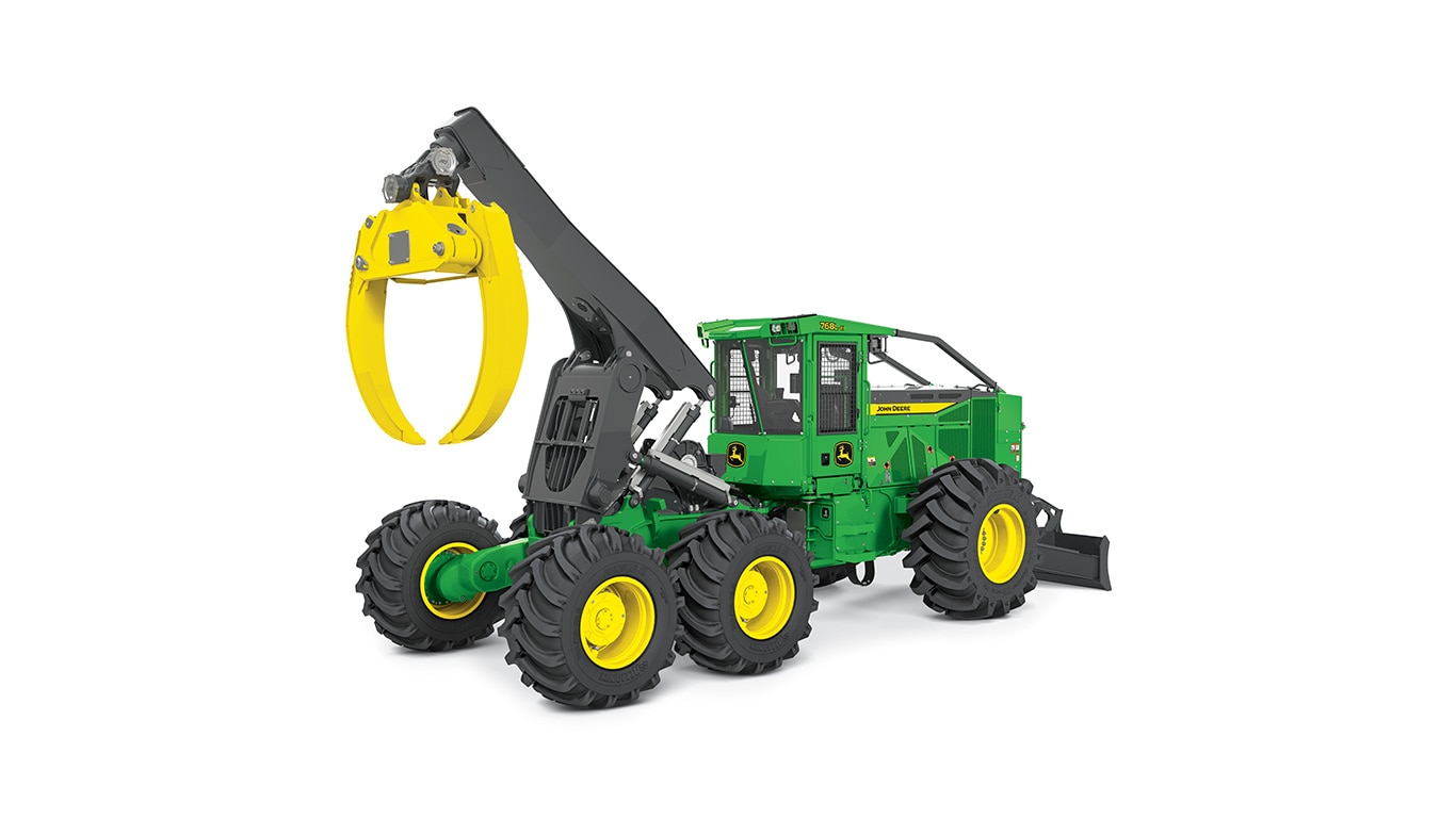Machine forestière verte et jaune avec de gros pneus et un bras de pince pour la manutention des grumes.