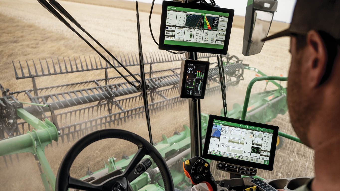 In cab view of operator and displays in combine