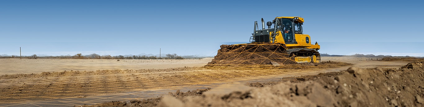 Un bouteur John Deere pousse la saleté, le sol étant superposé à une grille pour indiquer l’automatisation.
