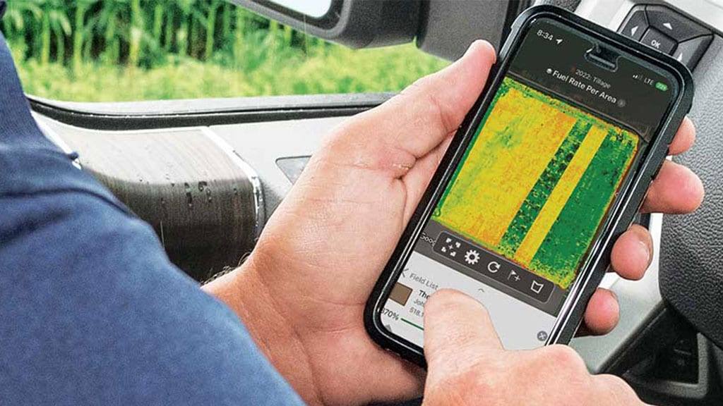 Image d'un homme utilisant son téléphone cellulaire pour voir son champ à distance à l'aide du Centre des opérations