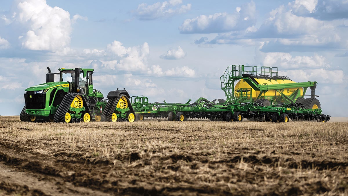 9RX 830 pulling air seeder in field