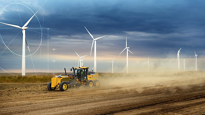 Une niveleuse automotrice 872GP de John Deere nivelle la surface d’un parc éolien au Montana, où Blattner Energy crée des solutions innovantes en matière d’énergie renouvelable.