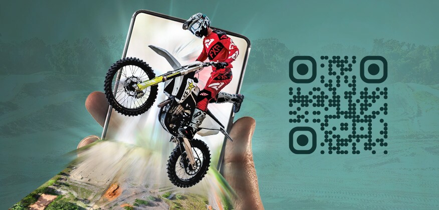 Hand holding a mobile device with a motocross racer and map of the race course bursting out its screen to represent augmented reality.