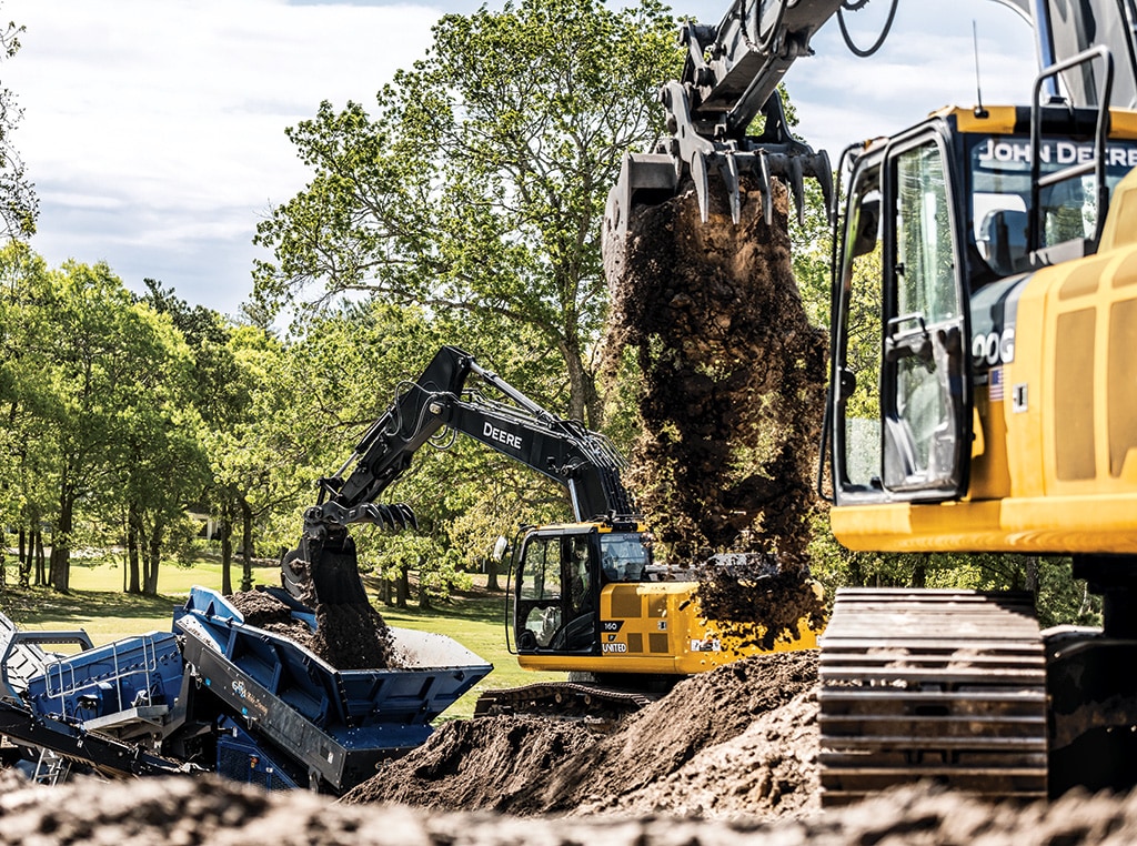 A 300G LC Excavator moves earth while a 160 P-Tier Excavator unloads dirt into a track-mounted stockpile conveyor.