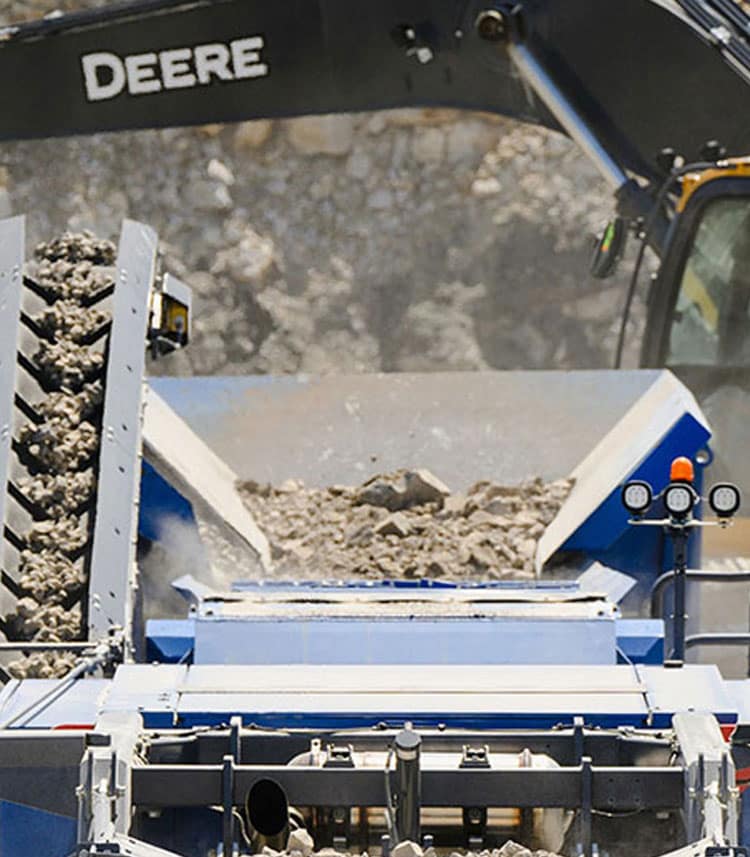 An excavator loads gravel in a quarry