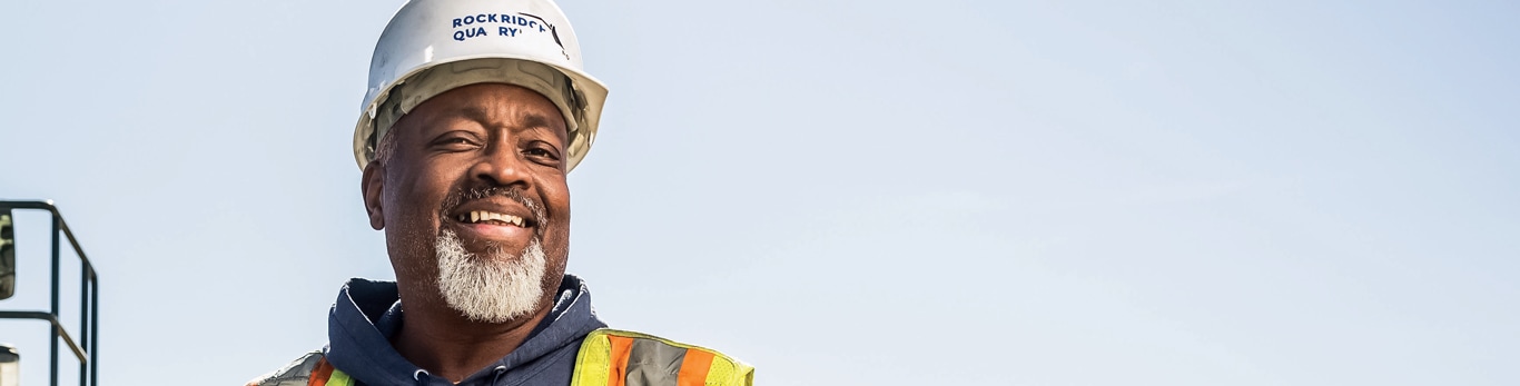 Head shot of Mark Franklin in front of a John Deere Wheel Loader