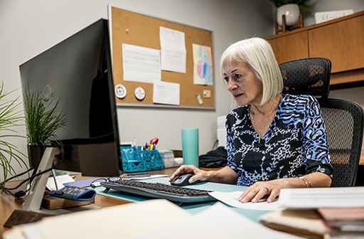 Donna DiGiovanni, senior vice president at GFM Enterprises, completes work on her computer.