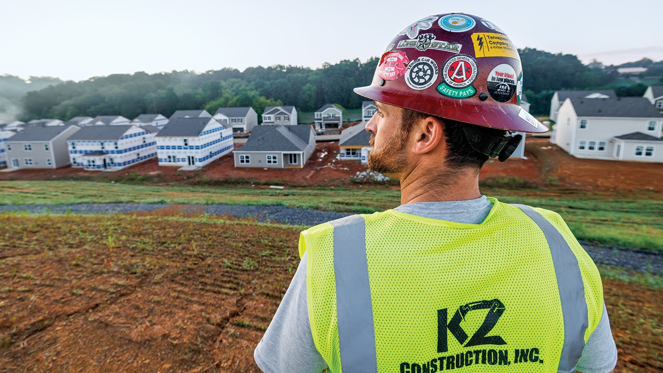 Thomas Karczmarczyk of KZ Construction looks across a housing development jobsite.