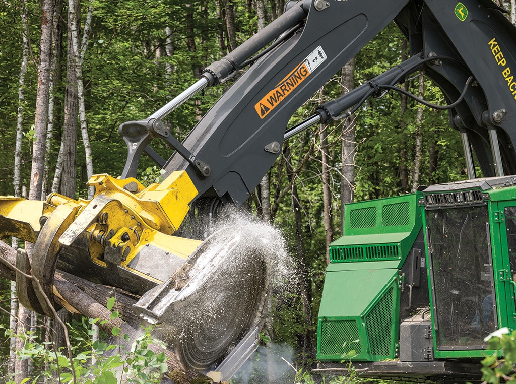 An 853M Tracked Feller Buncher with FR22B Felling Head is felling trees.