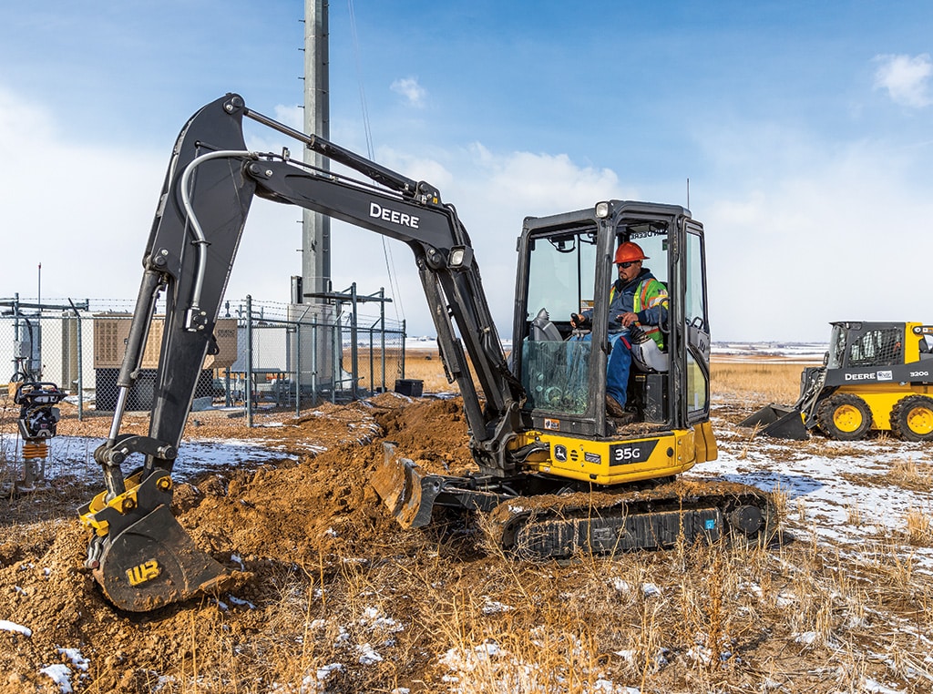 Compact Excavator digging on the worksite.