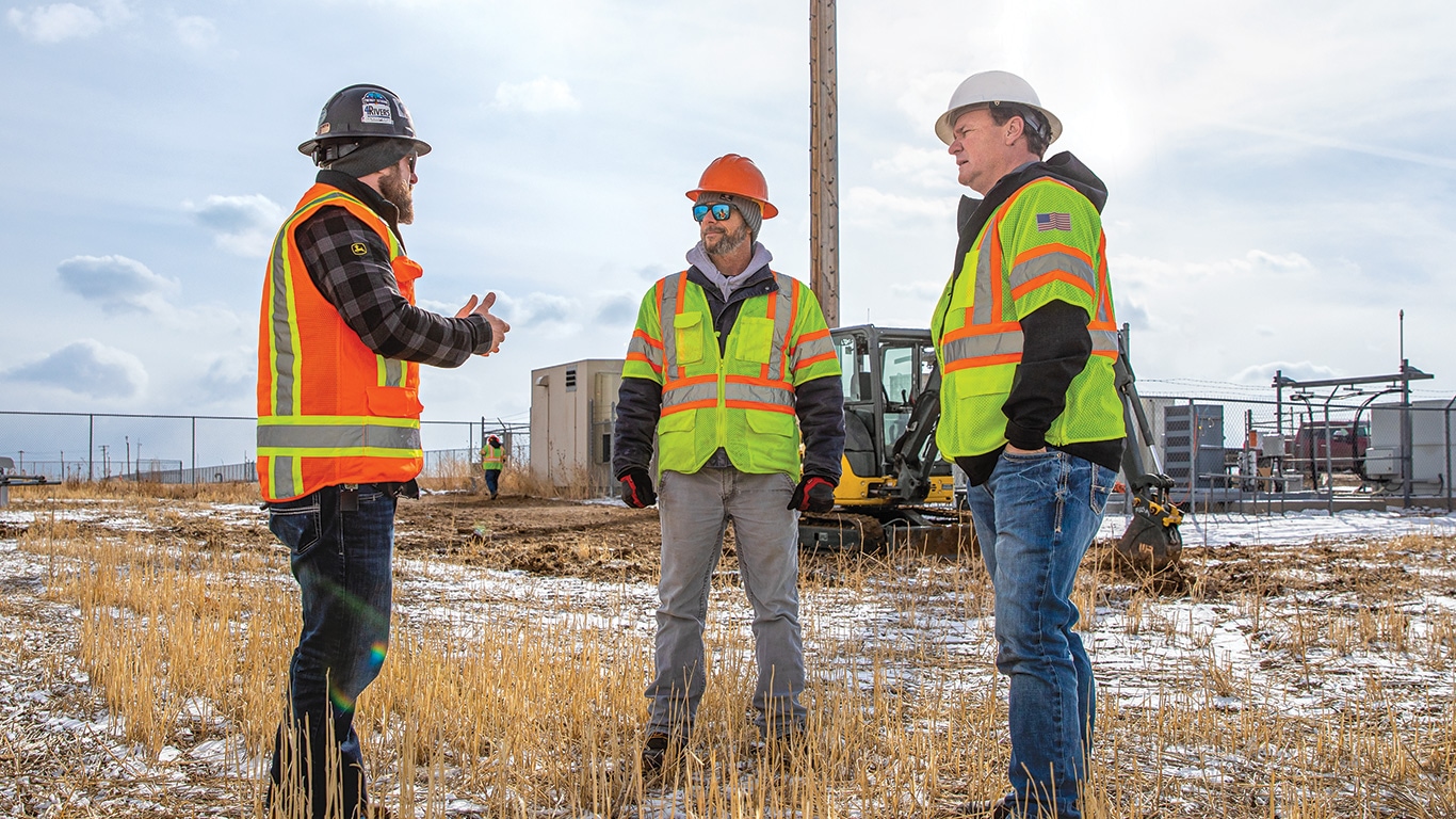 From left to right. Ben Tubach of 4Rivers Equipment discusses the jobsite with Chris Whitlock and Kevin Glynn of A to Z Field Services.