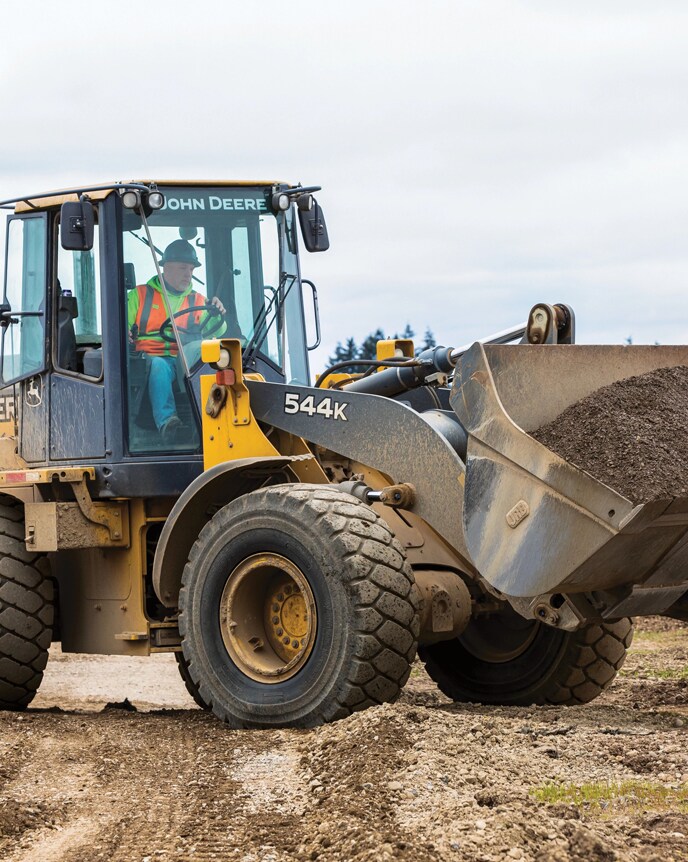 544K Wheel Loader carrying a load of dirt at a Kipco Construction worksite.