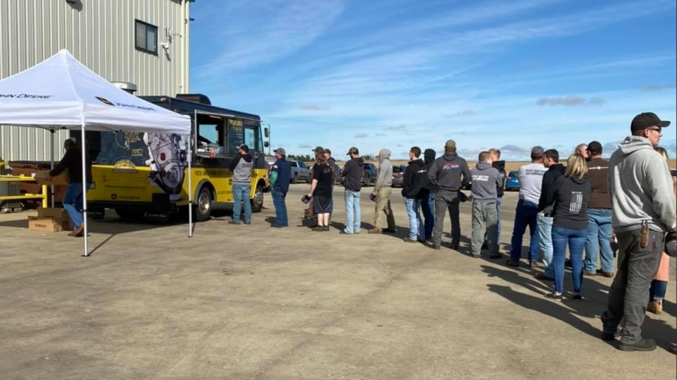 John Deere Power Systems Power Lunch food truck at Puck Enterprises in Manning, Iowa, with long line of OEM customers