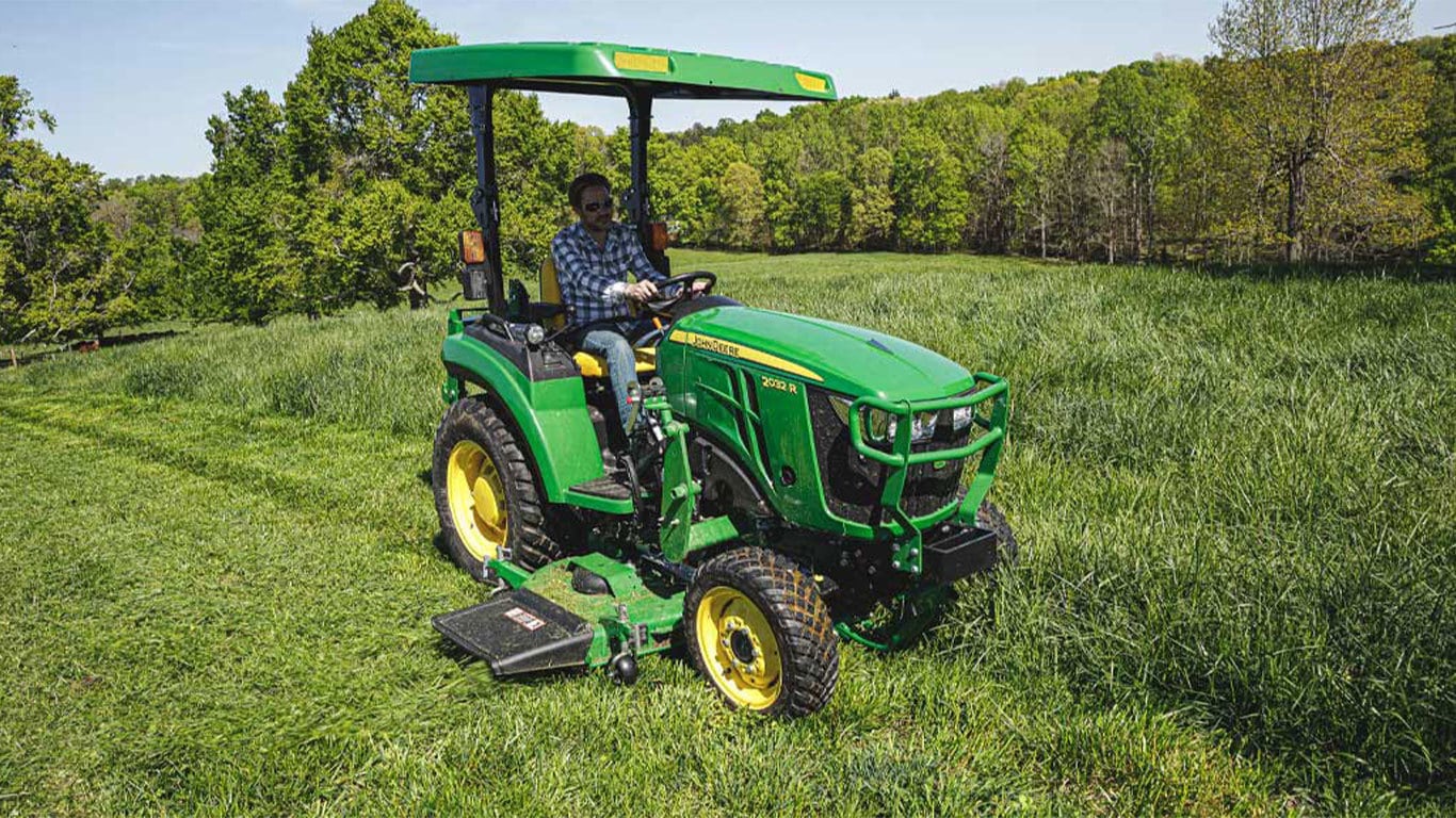 Man mowing grass with a 2032r tractor