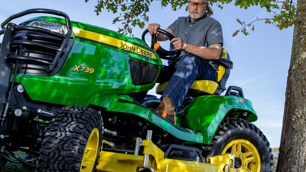 Close up image of man on riding mower