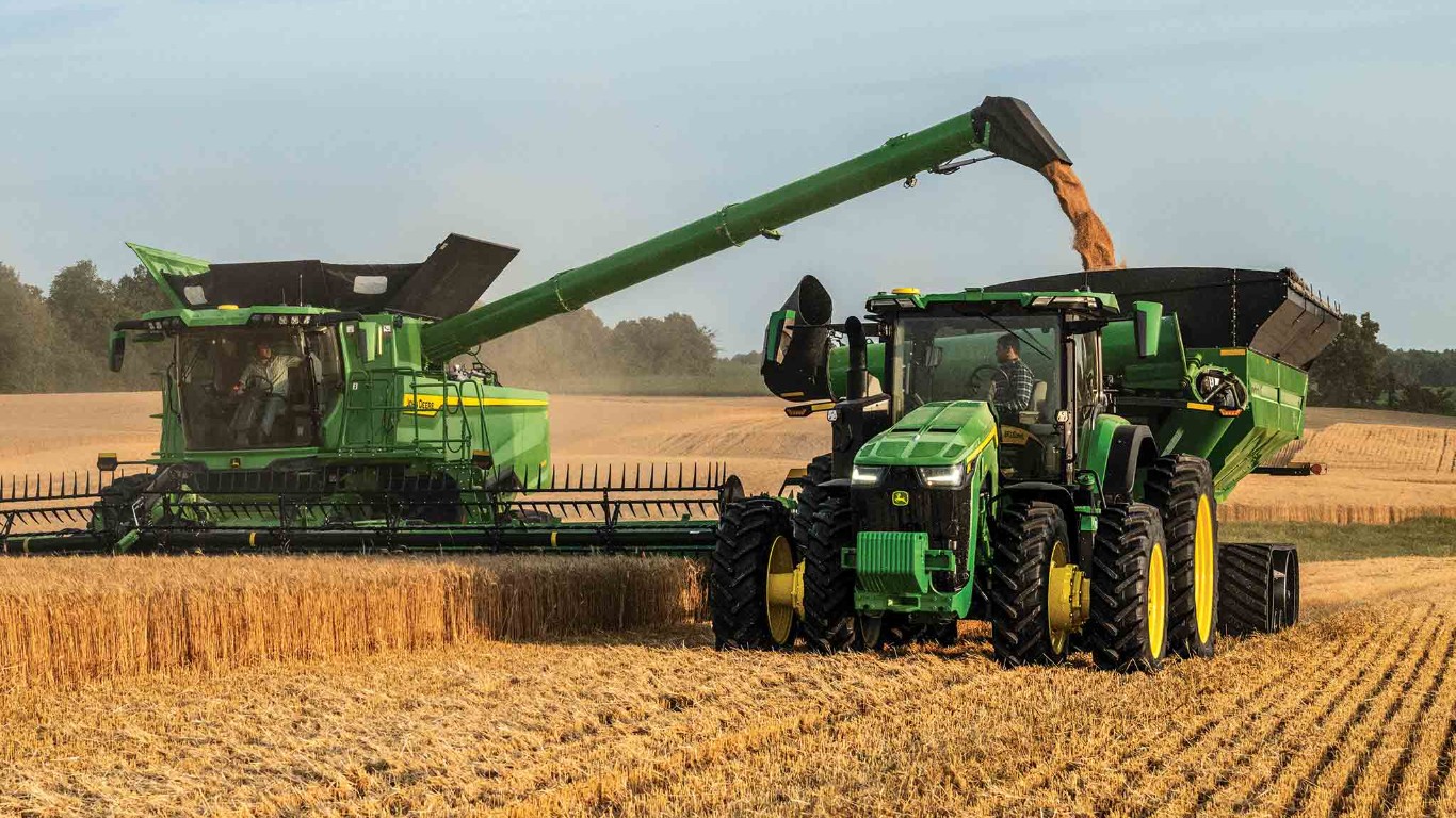 Combine in field pouring grain into a grain cart.