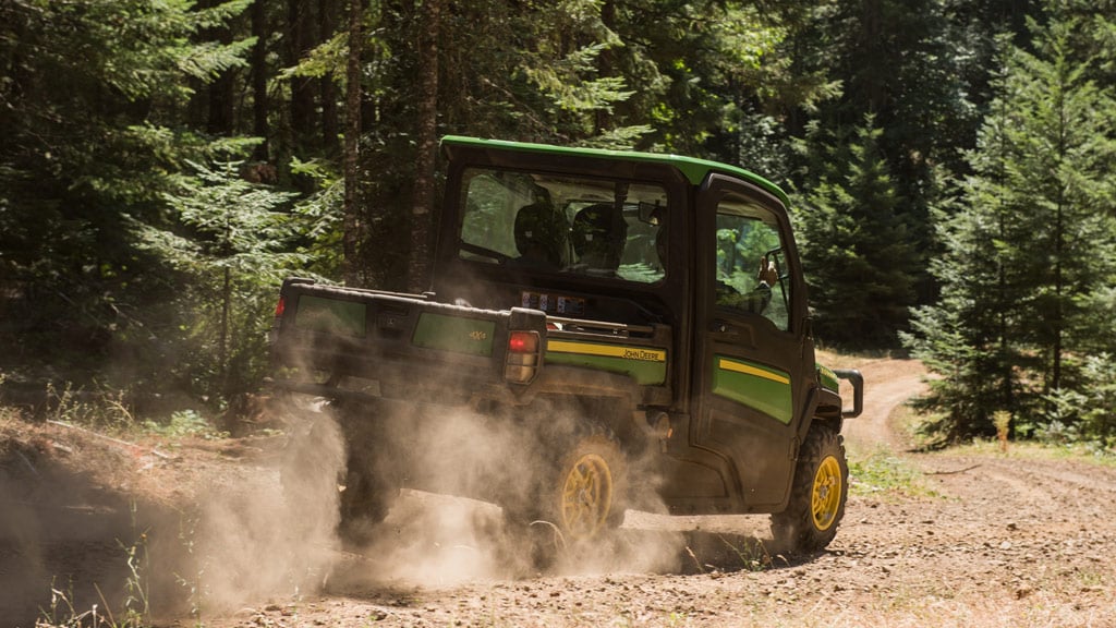 Gator™ XUV being driven through woods kicking up dust