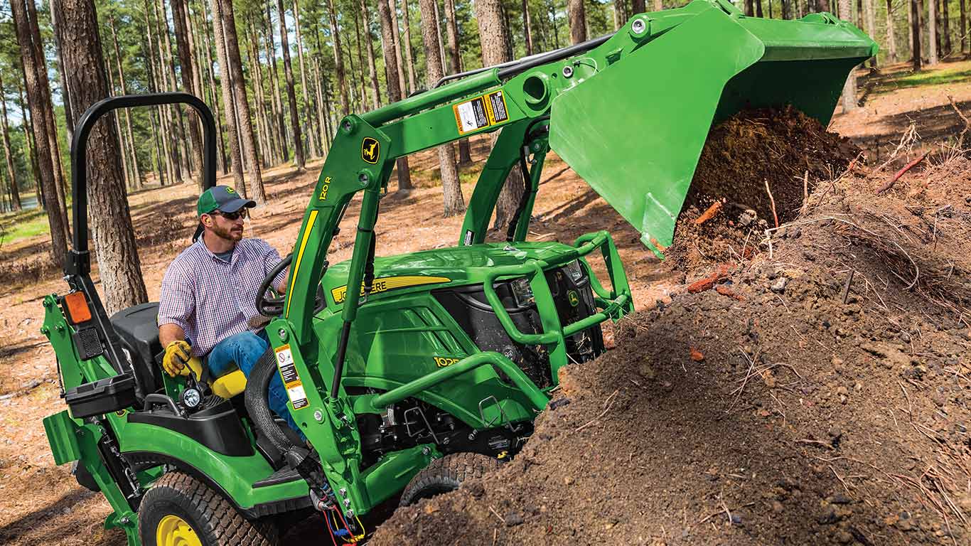 1 family tractor using front loader to dump soil