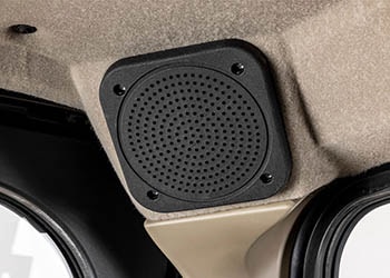 Square audio speaker with rounded edges built into the vehicle.