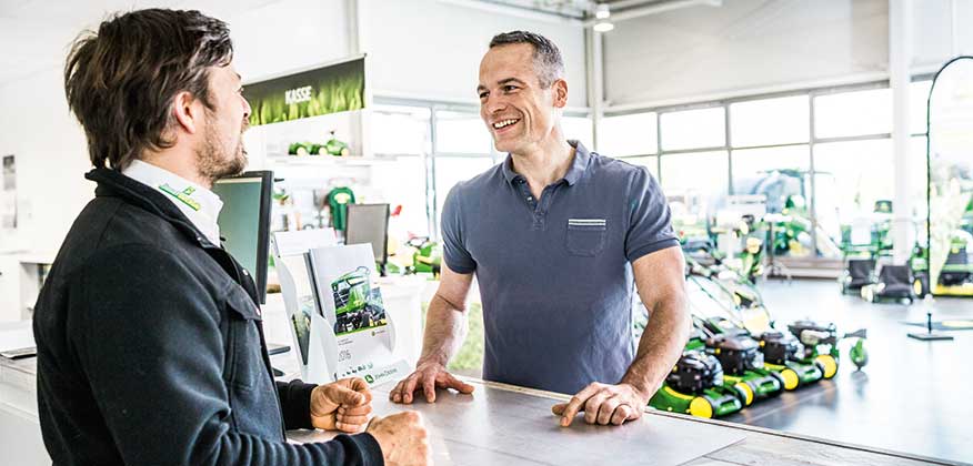 Dealer talking with customer over the counter