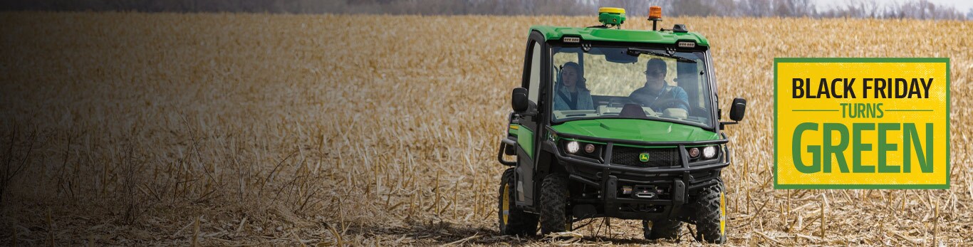 People in a gator driving through a farm field