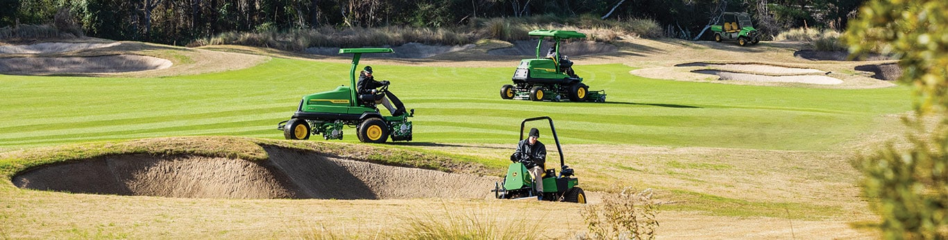Image of a golf course with bunker rake and fairway mowers maintaining it.