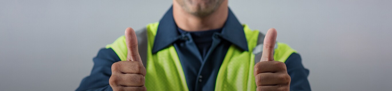 close up image of male worker with two thumbs up.