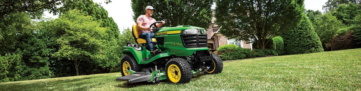 Person mowing a lawn using an X739 riding lawn tractor