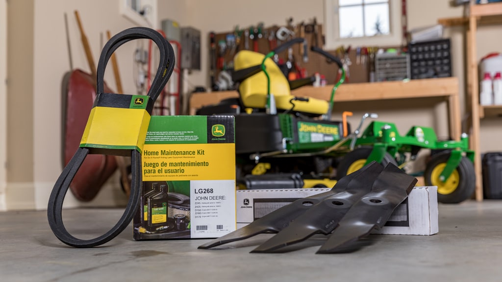 A Home Maintenance Kit sitting on a shop floor with a zero-turn mower in the background