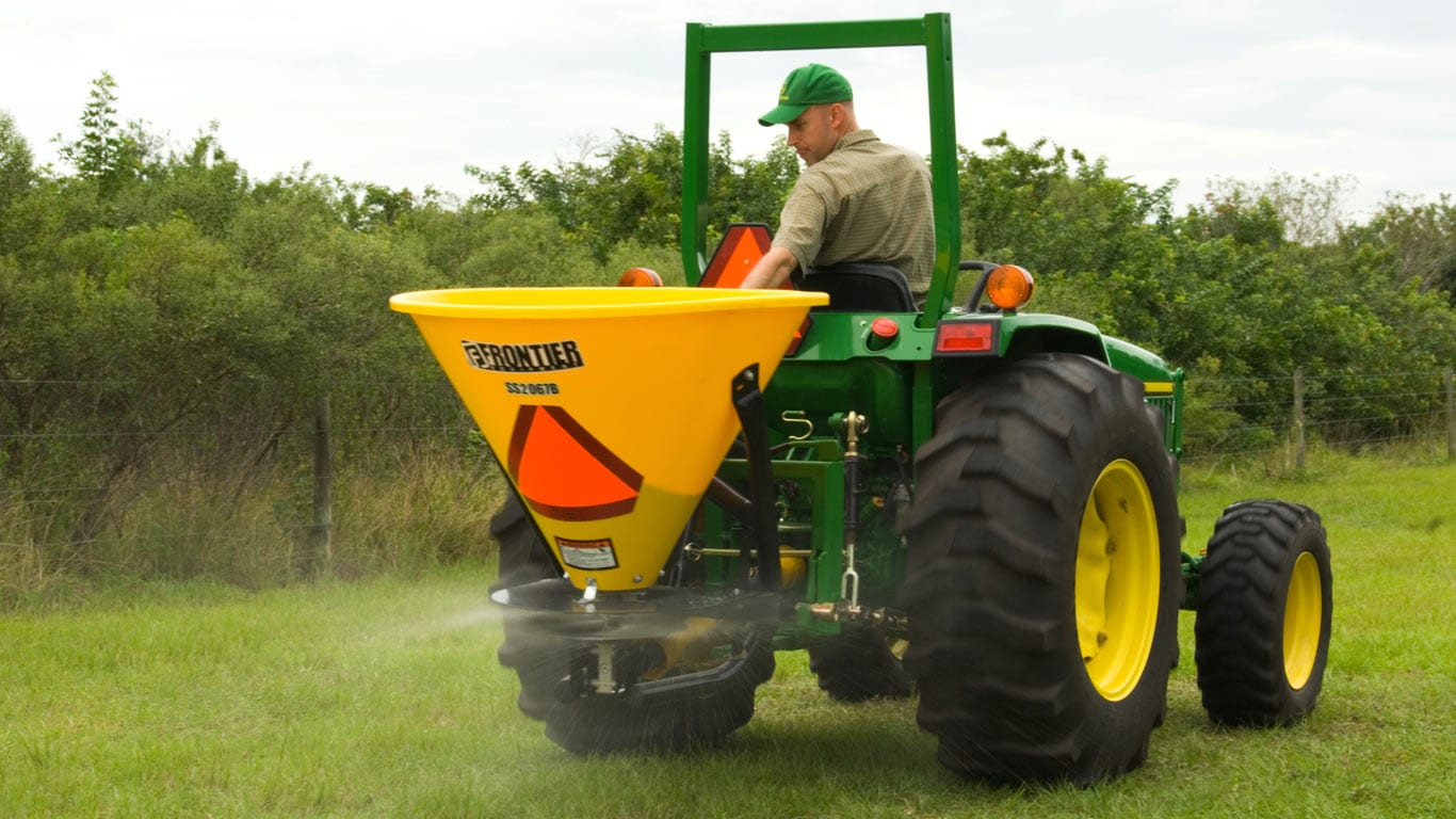 tractor with seeding attachment on in a field