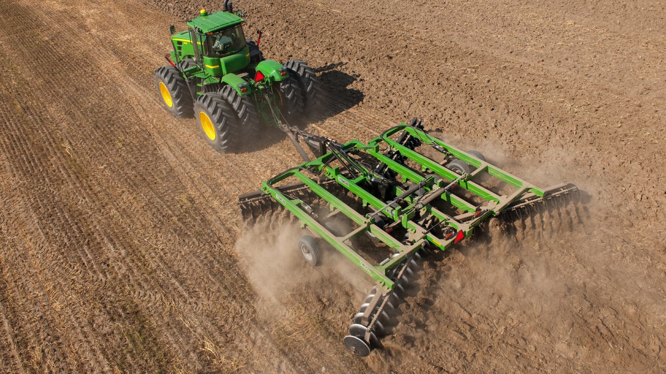 aerial view of tractor pulling tillage attachment in field