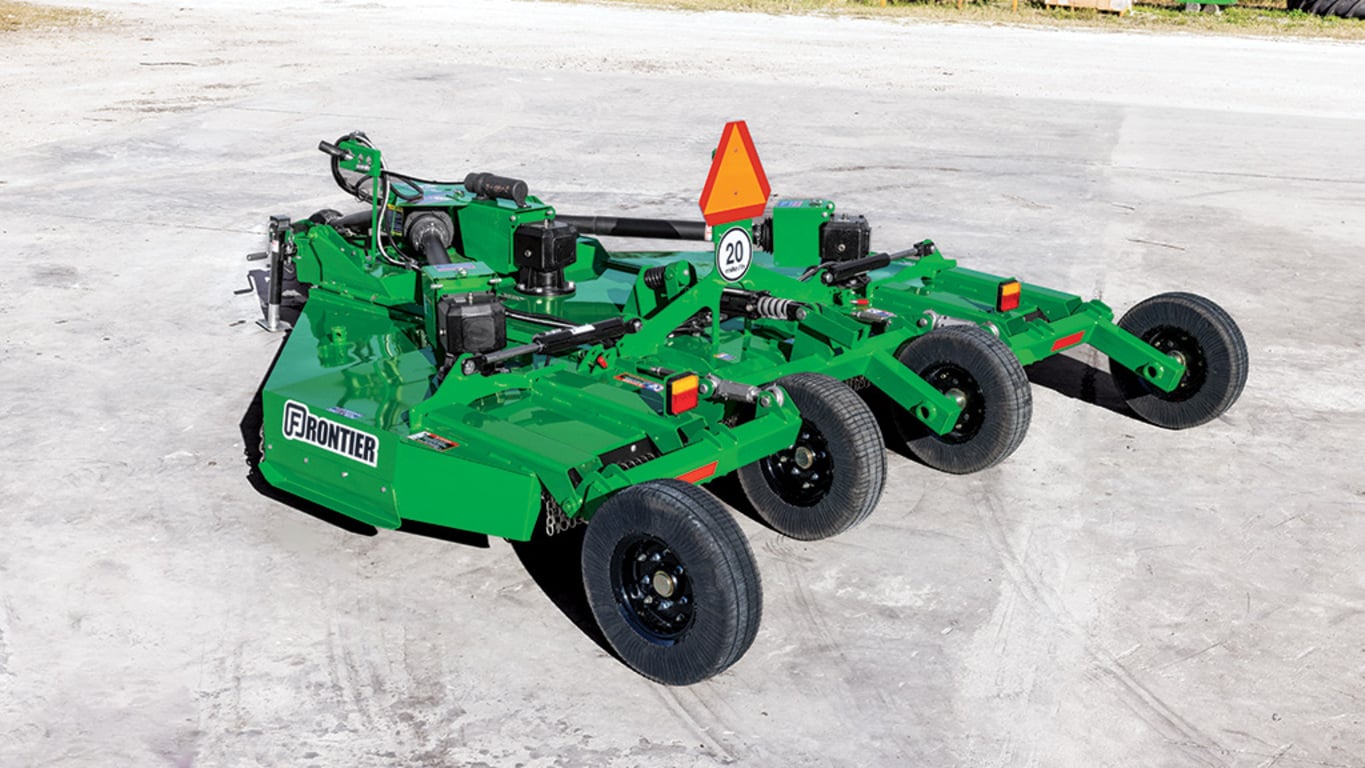 A green rear-right-facing FC5010 rotary cutter resting on pavement.