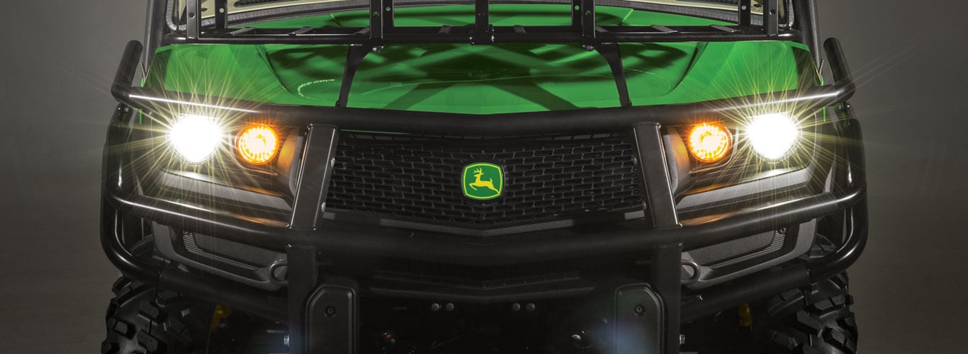 John Deere Gator with headlights shining