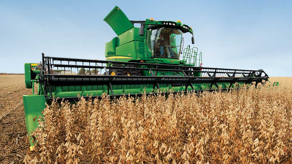 Photo of a John Deere Combine with a auger platform harvesting in small grains