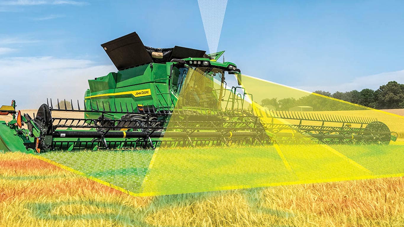 John Deere combine harvesting grain with Harvest Automation technology visualized across the field.