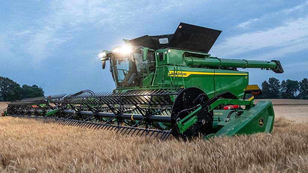 Photo of a John Deere Combine with a draper header in small grains
