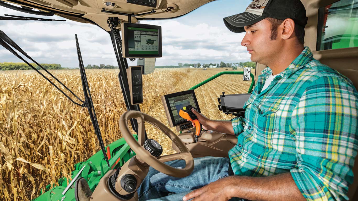 Photo of person in cab of combine