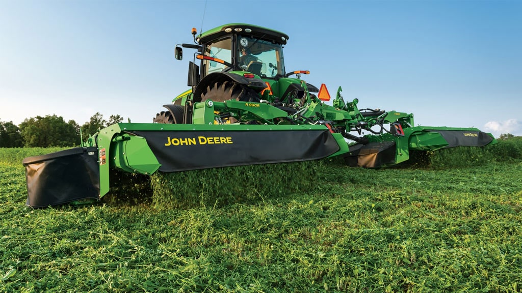 tractor and mower conditioner in a field