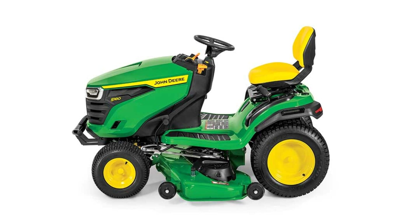 A left-facing green riding mower with a yellow seat and green mowing deck on a white background.