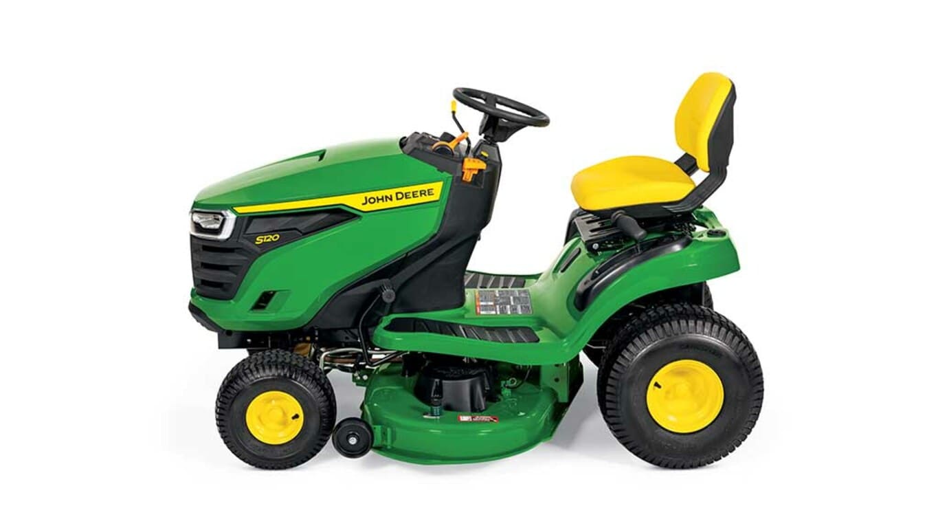 A left-facing green riding mower with a yellow seat and green mowing deck on a white background.