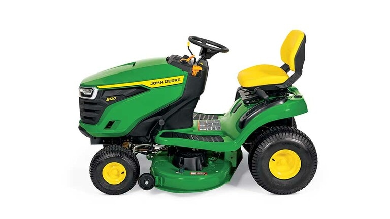 A left-facing green riding mower with a yellow seat and green mowing deck on a white background.