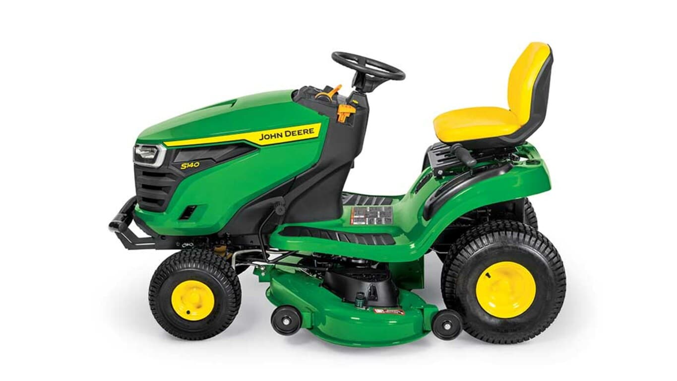A left-facing green riding mower with a yellow seat and green mowing deck on a white background.